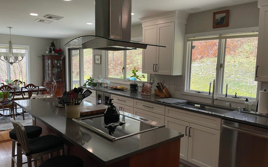 Open concept kitchen renovation in Connecticut with custom island, modern lighting, and dining area by Lagace Construction.