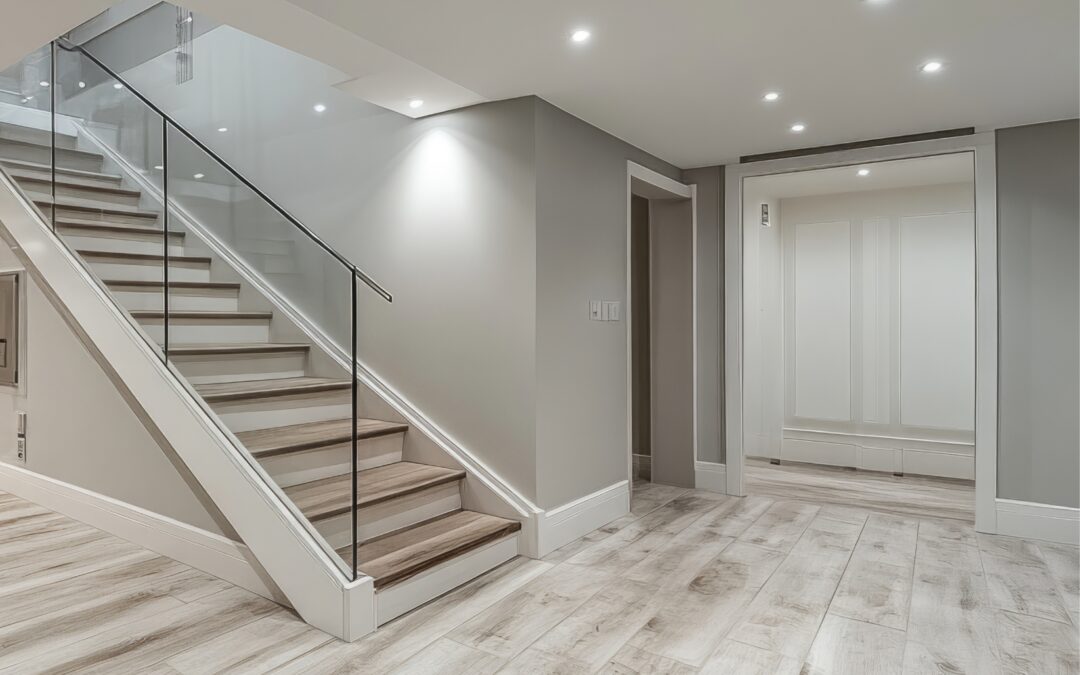 Basement finishing in Tolland County CT with light wood-look tile flooring, recessed lights, and glass stair railing